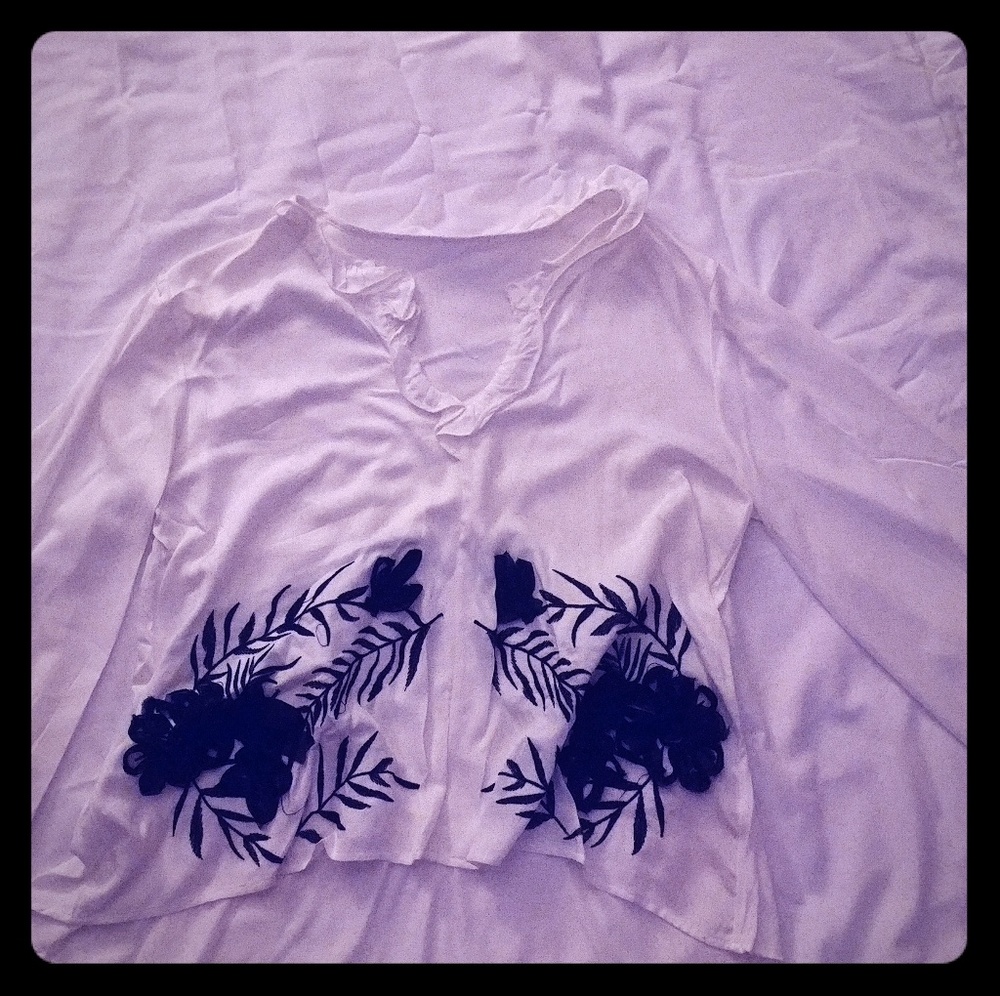 White blouse with black floral and leaf embellishm